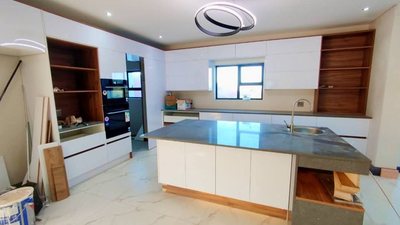 A refitted kitchen with a stone-topped island.