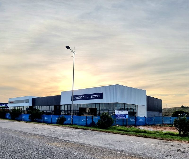A completed single-storey commercial building photographed at dusk.