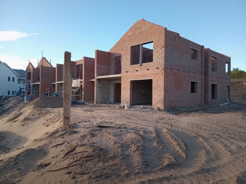 Brickwork rising on a multi-unit residential development.