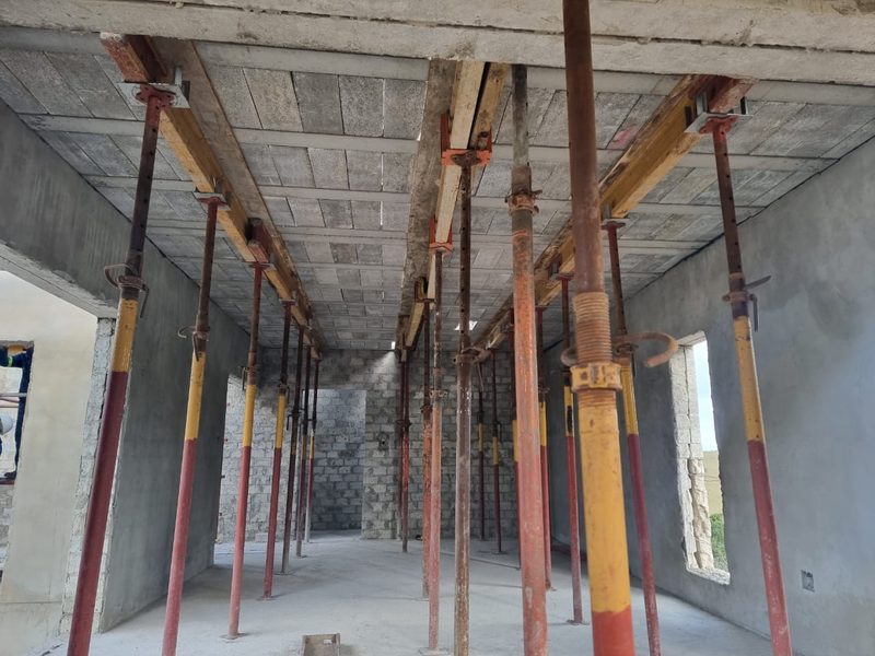 The interior of a cast concrete frame still supported on steel props.