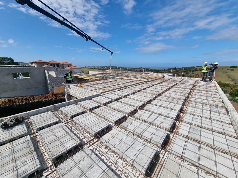 Deck formwork and fixed reinforcement on a slab with a crane boom overhead.