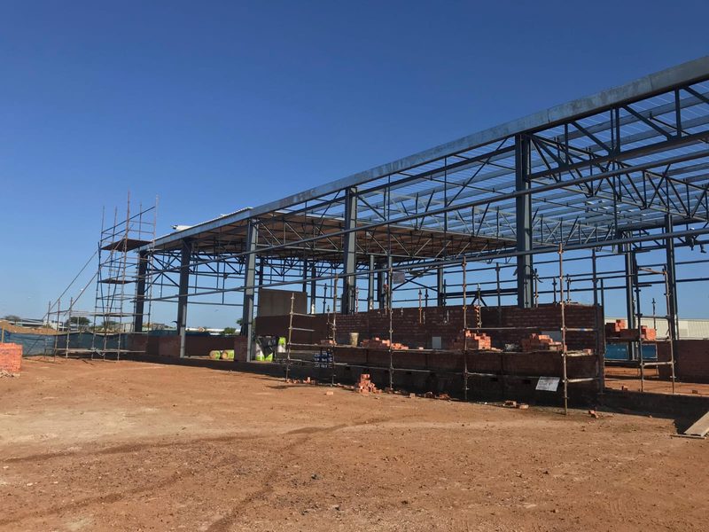 An erected steel portal frame for a large industrial building.